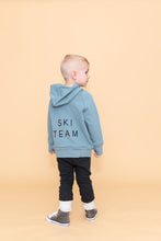 Load image into Gallery viewer, trademark raglan hoodie - ski team on rainwater (black)